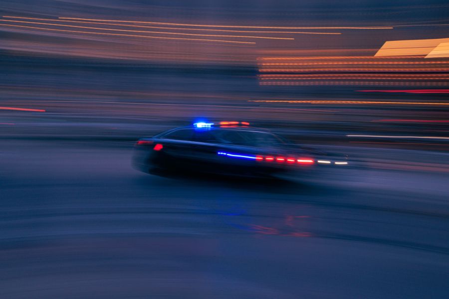 Police chase Fast moving police car down a city street. car,cops,motion
