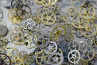 Metal artisans Macro of metal gears, cogs and wheels from old watches. cogs,metal,watchmaking