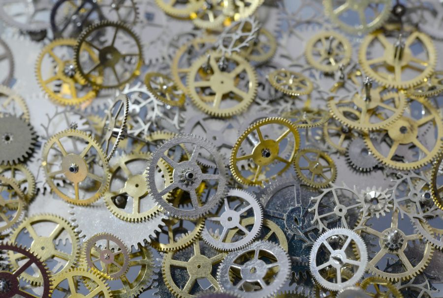 Metal artisans Macro of metal gears, cogs and wheels from old watches. cogs,metal,watchmaking