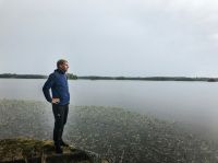 Men s Middle aged man looking out over the lake. 