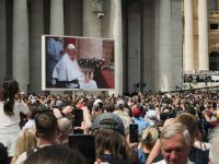 Pope visit Pope Francis appearing for the last time on the St. Peter's Square in Vatican on Easter Sunday the 20th of April 2025 in front of the crowds. The Pontiff on a wheelchair is visible on a big screen, and the people gathered on the square are filming and photographing it. 