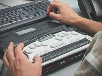 Accessibility Blind man using a braille screen reader. canada,qc,québec