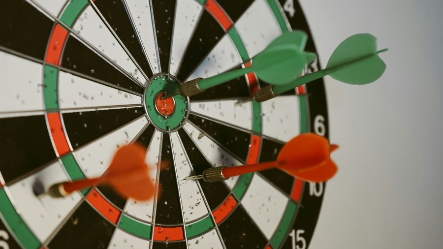 goal Success hitting target aim goal achievement concept background - three darts in bull's eye close up. red three darts arrows in the target center business goal concept 