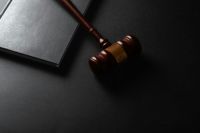 Courtroom exhumation Judge gavel and book on black background. Law and justice concept 