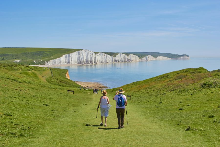 Retirement An old couple walking towards the Seven Sisters 
