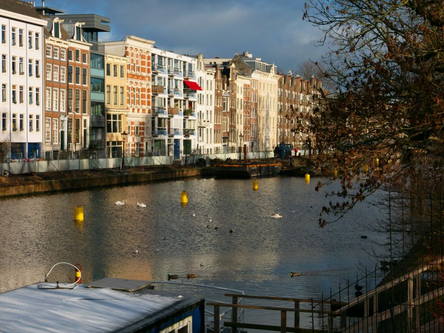 Renovation Photo of a view over the old canal Nieuwe herngracht in Amsterdam city; the old quays along the canal needs reconstruction. I like the mixture of sunlight and shadows and textures in the water surface. To the right the Wertheimpark. Everything under a grey sky. Street photography of urban city canals in Amsterdam downtown, The Netherlands by Fons Heijnsbroek, 2024; Dutch photographer // Foto van Amsterdam Nieuwe Herengracht op de hoogte van het Wertheimpark in de Plantage, gratis download, Neder amsterdam,nieuwe herengracht,netherlands