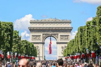 Bastille Day Arc de Triomphe with a France national flag on Bastille Day.