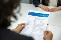 Job application Closeup view of job applicant resume and CV paper during job interview 