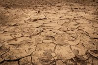 drought agriculture A desolate dusty brown riverbed with dry broken clay soil 