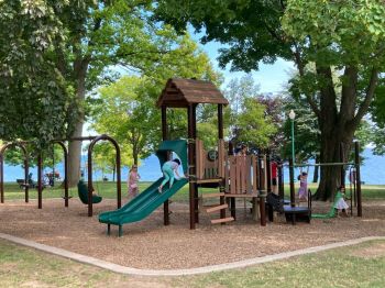 children playground Children playing on play structure in public park by Lake Ontario
