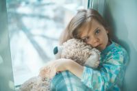 Child illness a sick child with a fever sitting at home in quarantine 