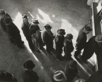 Unemployment 1938 - Unemployment benefits aid begins. Line of men inside a division office of the State Employment Service office at San Francisco, California, waiting to register for benefits on one of the first days the office was open.
Photographer - Dorothea Lange  