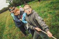 Summer camp These children play the ancient game of tug-of-war. The photo was taken on the day during the festival of children’s creativity. Young actors from different cities of Bashkortostan Republic shared their experience, performed dances and songs. kid,school,team