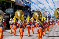 parade Marching band in orange uniforms on the main street 