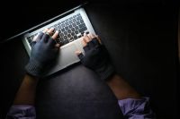 threat security hacker hand stealing data from laptop top down  person,crime,hacking