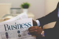 News Business Businessman opening a paper 