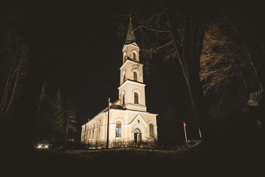 church night White lutheran church with tower in the middle of the night. 