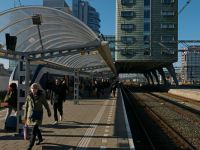 Travellers Gypsies Photo of walking people , leaving the train on platform 1. of Central station Amsterdam on a sunny day in early Spring with contrasting dark shadows. In the background the modern architecture of the IBIS-hotel with its concrete columns, holding up the building above the train track. Dutch station photography of Amsterdam city in free station photo; Urban street photography by Fons Heijnsbroek, The Netherlands, March 2022. netherlands,amsterdam,train