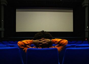 Movie theater Homme seul devant un écran de cinema. Blue and orange. Cinema, Theatre, film, screen.
