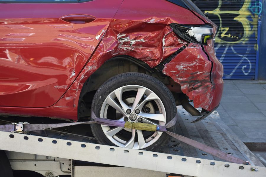 car accident Image of a red car being towed/recovered which was involved in a road traffic collision. 