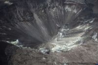 crater collapse Aerial view of Halema‘uma‘u at the summit of Kīlauea taken during a USGS Hawaiian Volcano Observatory helicopter overflight on August 1, 2019. The small green patch visible at the bottom of Halema‘uma‘u is a new pond forming at the lowest point of the crater. The pond is at about 525 m (about 1722 ft) elevation. 