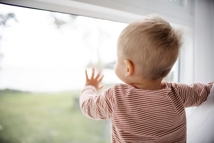 Childcare shortage Baby Boy looking out the window boy,kids,hand on window