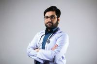 Doctor salary A doctor wearing stethoscope and medical coat with corner pose 