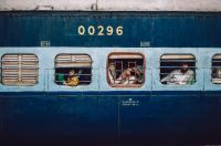 Train passenger Not pictured are the clickety clacks of metal, the yells, whistling air, announcements far too loud for the speakers and wheeled trolleys on tiles. 

And pictured is a train pulling into the Hazrat Nizamuddin railway station. Along with it comes the weary travellers and riders looking out of their gated compartments. Some are too tired even to peer out, keeping their windows closed. 