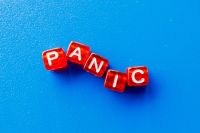 Wrong way the word panic is laid out from red cubes on a blue background word,letters,panic