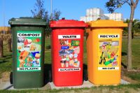 waste Three brightly colored waste bins placed where they can easily be found and used . 