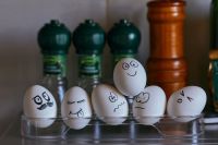 psychologist Emotional background with eggs and condiments in the kitchen. Painted faces on eggs for Easter. Emotions, smiles, mouths and eyes on chicken eggs russia,egg,emotions wallpaper