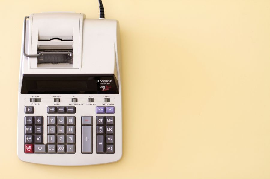 Budget Ten key accounting calculator on yellow desk. 