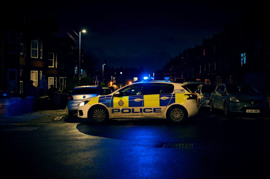 Crime scene British police car with emergency lights flashing 