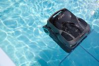 Pool robot AIPER pool cleaner glides through clear water, actively removing dirt and debris from the pool floor. 