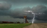 Thunderstorm Train Lightning strike near a grain elevator 