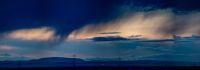 Rain Showers As the day nears its end, these panoramic images reveal the stark beauty of an industrial horizon under the threat of stormy weather. The interplay of light showers and the remnants of daylight creates a dramatic skyscape, with the silhouettes of power lines and wind turbines adding a stark contrast. These photographs capture the intricate balance between industry and nature, suitable as widescreen wallpapers that bring a dramatic flair to any display. landscape,panoramic,atmospheric