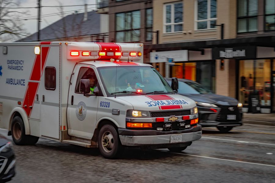 Paramedics strike Ambulance rushes to an emergency call with flashing lights and sirens. BC Ambulance Service vehicle in Vancouver Canada. 