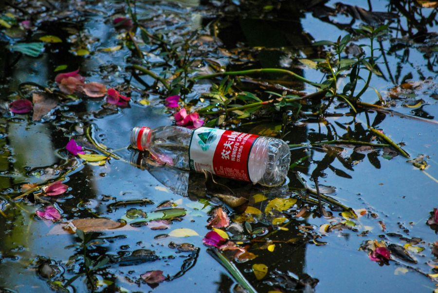 Lake pollution An empty bottle of water in a lake. 