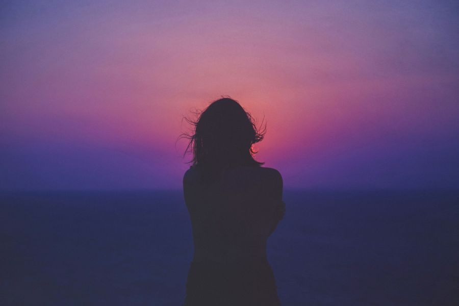 woman silhouette Sun was setting down. Those magical colours where blinding. I wanted this moment to last forever. She was smiling, but tears where coming from her eyes. I remember their salty taste. My heart was beating faster than usual. I did not know what to say. Summer was over. Our last night. We knew that we will probably never see each other again, but no one wanted to believe in that. We were happy and lost. Lost in this sunset forever. 
