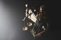 Burglary Justice Statue of justice and scales of justice on a black background. 