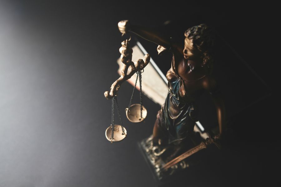 Burglary Justice Statue of justice and scales of justice on a black background. 