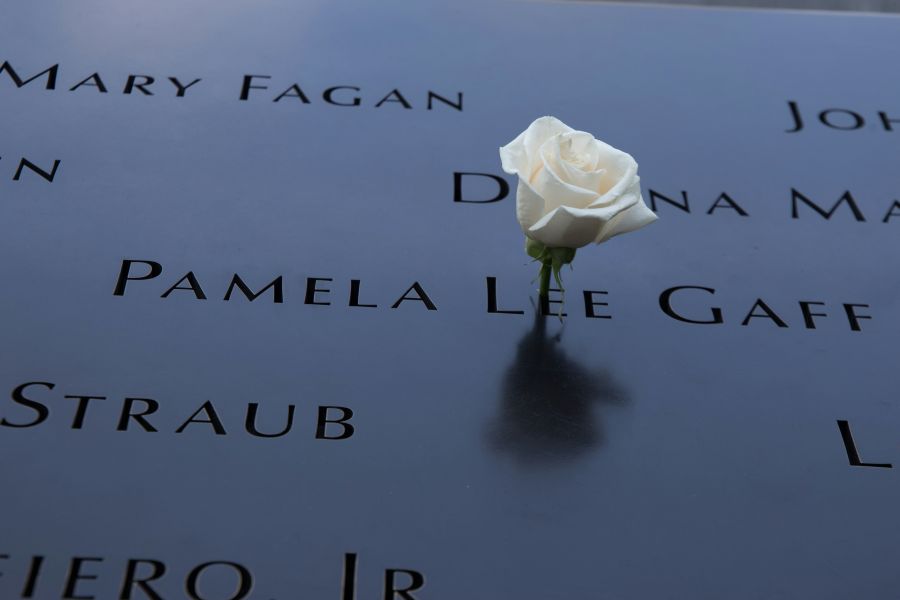 Memorial I visited Ground Zero Memorial. This shot is of the the plaque in memory of the fallen heros. Friends and family have placed this white rose in remembrance of their loved ones 